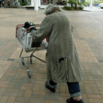 homelessness - someone pushing a trolley of possessions