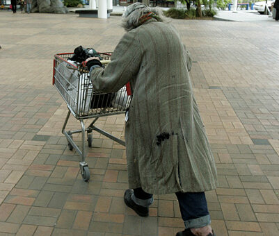 homelessness - someone pushing a trolley of possessions
