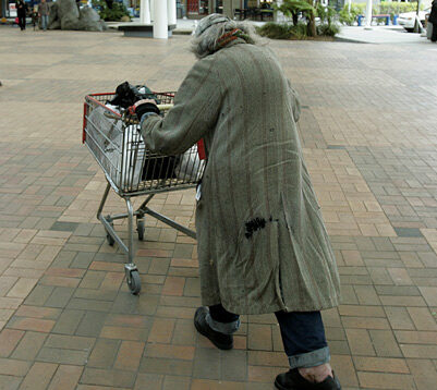 homelessness - someone pushing a trolley of possessions