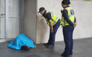 Police with homeless person